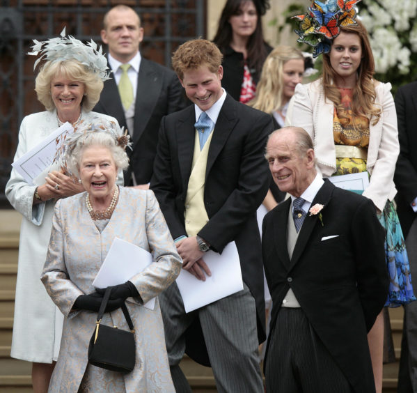 (left to right) The Duchess of Cornwall, Queen Elizabeth II, Mike Tindall, Prince Harry, Zara Phillips, The Duke of Edinburgh and Princess Beatrice leaving the St George's Chapel in Windsor after attending the marriage ceremony of Mr Peter Phillips and Miss Autumn Kelly.