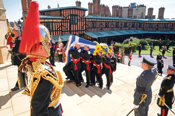 The Duke of Edinburgh's coffin, covered with his Personal Standard, is carried into St George's Chapel, Windsor Castle, Berkshire, ahead of the funeral of the Duke of Edinburgh.