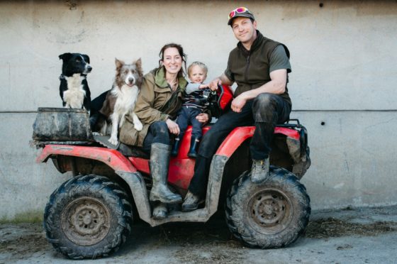 Emma Gray with her husband Ewan Irvine and son Len, aged two, on their farm on the Isle of Bute.