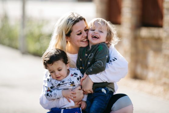 Young mother Leigha Collins being reunited with her son, Alfie (right), who she hasn't seen for months, after a judge ordered her to go back to Malta (with her other son Hayes, left)
