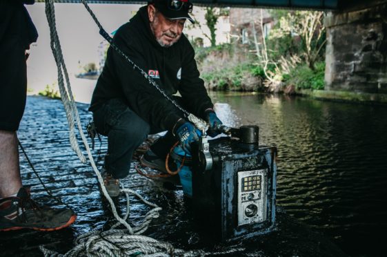 Magnet fisher John Robertson pulled an empty safe out of the canal