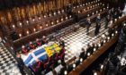 Queen Elizabeth II watches as pallbearers carry the coffin of the Duke of Edinburgh during his funeral at St George's Chapel, Windsor Castle, Berkshire.