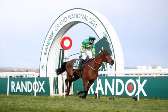 Rachael Blackmore, the first woman jockey to win the Grand National, roars with delight as she clears the finishing line on Minella Times