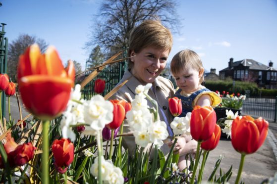 Nicola Sturgeon with Alisa Innes, the daughter of SNP candidate Natalie Don, on the campaign trail in Renfrew