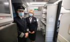 Aircrew wear masks to welcome passengers back on board as Which? warns travellers to check their travel insurance cover