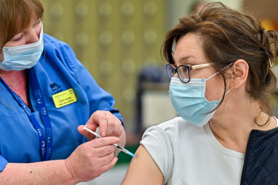 Natalyia Dasiukevich receives her Covid-19 vaccination from nurse Carol McGlion at Allander Sports Centre in Glasgow