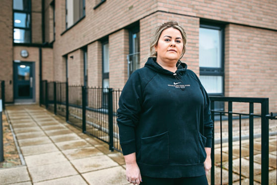 Gemma Neil in front of her flat in Glasgow.