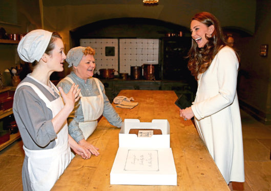 Sophie McShera, as Daisy, and Lesley Nicol, as Mrs Patmore, meeting Kate on Downton set