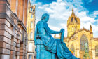 Royal Mile street in Edinburgh, Scotland. Old statue of David Hume.