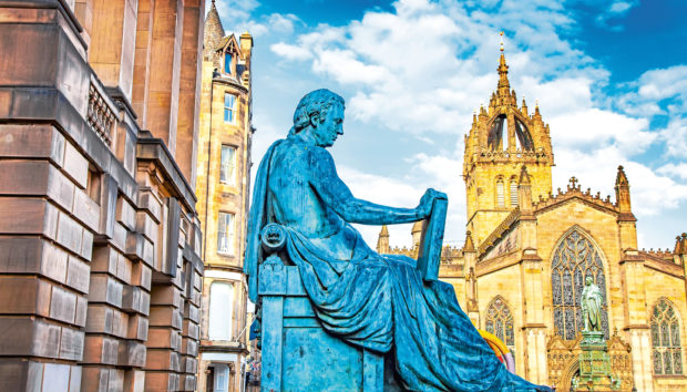 Royal Mile street in Edinburgh, Scotland. Old statue of David Hume.