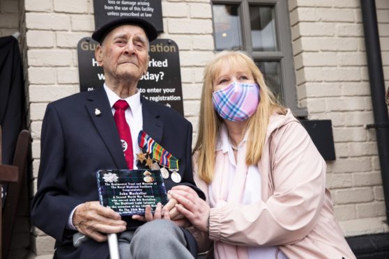 John MacKellar, with niece Linda Murray, watches the parade