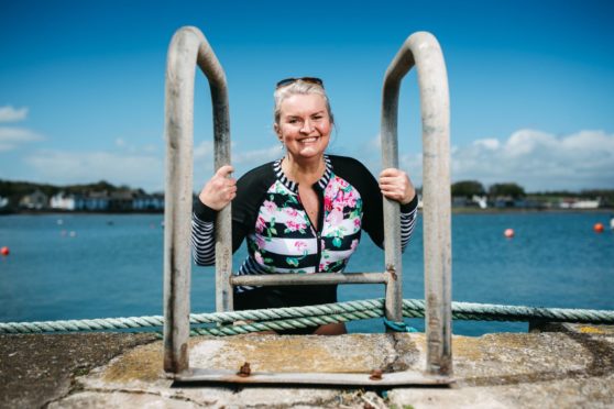 Kathleen Hart heads off for her daily swim in Wigtown harbour