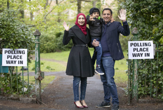 Scottish Labour party leader Anas Sarwar, with wife Furheen and son Ailyan, arrives to deliver his postal vote at Pollokshields Burgh Hall in Glasgow