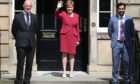First minister Nicola Sturgeon waves on the steps of Bute House in Edinburgh alongside John Swinney and Humza Yousaf after announcing her new cabinet