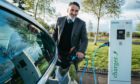 Tesla driver Ron Mackenna powers up his Tesla at a charging point in Glasgow