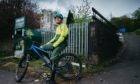Mountain biker Ruairidh MacKenzie out side St Martin's Church in Castlemilk, Glasgow, which was meant to be turned into a mountain bike hub, as a legacy project after the Commonwealth Games in Glasgow.