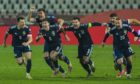 Scotland players start the sprint to get to keeper, David Marshall, after his penalty shoot-out heroics in Belgade last November. Three of them – Ryan Jack, Callum Paterson and Leigh Griffiths – are not now in the squad