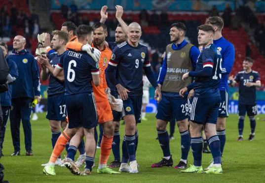 Kieran Tierney and David Marshall embrace at full-time as Scotland’s players                       enjoy the moment after drawing at Wembley.