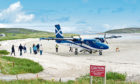 Passengers board a Loganair flight at Traigh Mhor beach, Barra in the Outer Hebrides
