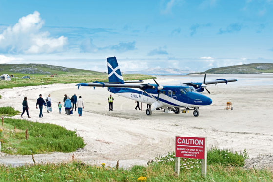 Passengers board a Loganair flight at Traigh Mhor beach, Barra in the Outer Hebrides