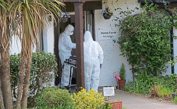 Funeral directors in hazmat suits enter Home Farm care home on Skye, where 10 residents died of Covid in May last year