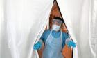 A technician at the entrance to the Covid-19 testing lab at Queen Elizabeth University Hospital, Glasgow.