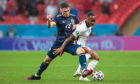 Billy Gilmour lets England’s Raheem Sterling know he’s in a game during the goalless draw at Wembley on Friday night