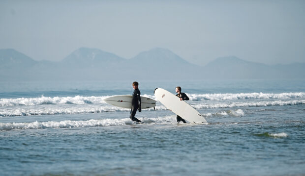 Surf-seekers in the water in Scotland.