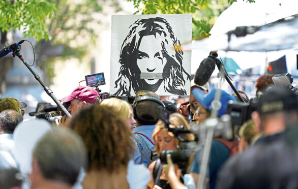 Portrait of Britney Spears looms over supporters and media members outside a court hearing concerning the pop singer's conservatorship at the Stanley Mosk Courthouse, in Los Angeles.