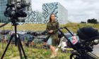 BBC foreign correspondent Anna Holligan reports live to camera from the International Criminal Court in The Hague with daughter Zena in baby buggy just out of shot