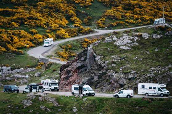 Campervans on the road near Durness.