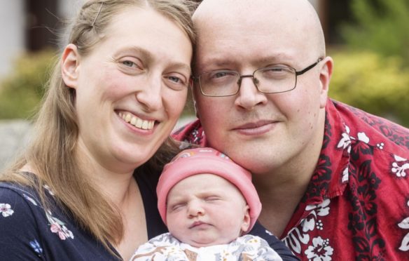Parents Margaret Paluszynska and Richard Winfield with baby Isabella at home in Archiestown, Morayshire
