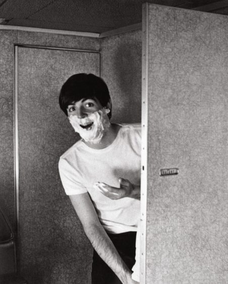 Going to America, 1964
Having a shave as The Beatles prepare for their first American visit: “This was taken on a plane to New York. Paul wanted to look fresh for The Beatles arriving in the United States. It was their first trip and they weren’t sure how they were going to be received. Paul wanted to look clean and tidy, and it was important for me that he did. I didn’t want him looking as if he had just got off a bus at 4am.”