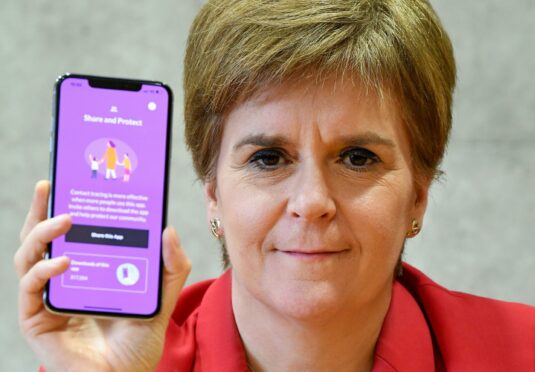 First Minister Nicola Sturgeon views the Covid-19 track and trace app