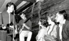 The Quarrymen featuring John Lennon and Paul McCartney perform onstage at their first concert at the Casbah Coffee House – the drummer Pete Best’s basement – with Lennon’s future wife Cynthia, right, on August 29, 1959 in Liverpool