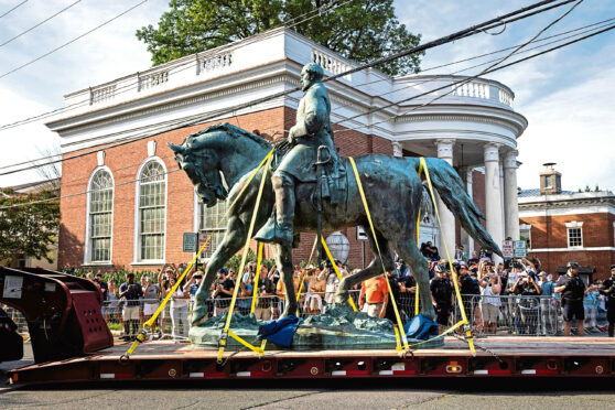 Workers haul away the statue of Confederate General Robert E. Lee from Market Street Park in Charlottesville, Virginia.