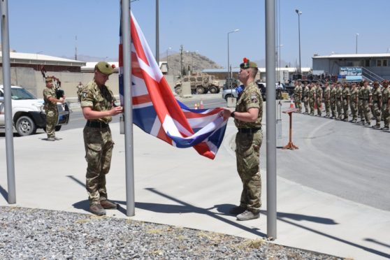 Royal Regiment of Scotland soldiers take down the British flag at Bagram Air Base, Afghanistan last week