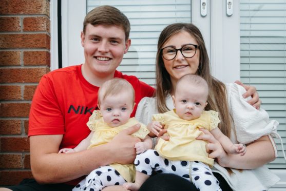 Baby Ivy (right) Hinde, with her twin sister, Holly, and parents Chloe and Aaron Hinde.