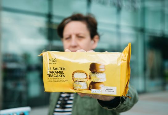 Baker Kirsteen Paterson holds M&S teacakes, made at the McVitie’s factory, during a demonstration at The Fort, Glasgow