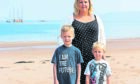 Laura Gallagher with sons Nathan, left, and Jamie at Thorntonloch beach, Dunbar