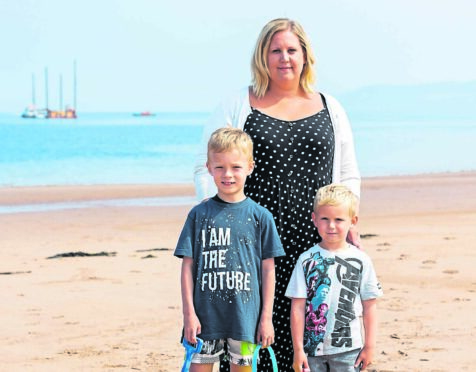 Laura Gallagher with sons Nathan, left, and Jamie at Thorntonloch beach, Dunbar