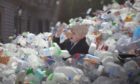 A model of Boris Johnson is swept out of Downing Street in a deluge of plastic waste in a campaign film from Greenpeace