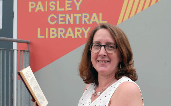 Paisley Central Library Team Supervisor, Linda Flynn with the Mrs Balbir’s Singh’s Indian Cookery book that was returned more than 50 years overdue