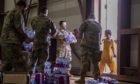 Young refugee gets water at US base in Qatar