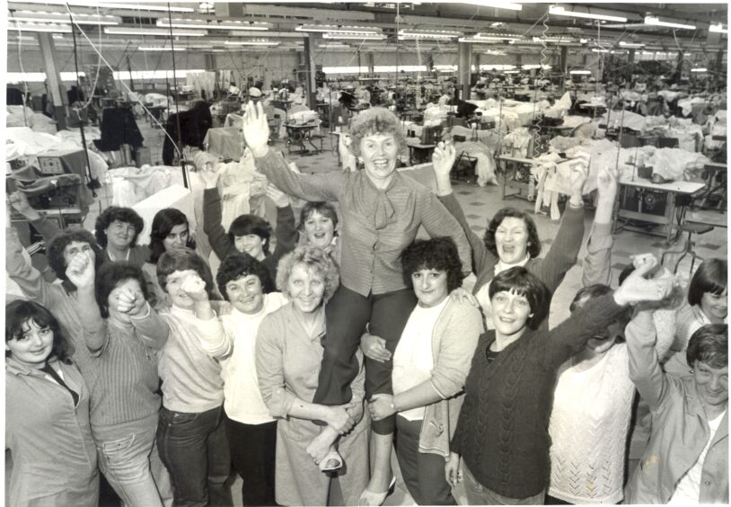 Shop steward Helen Monaghan is raised aloft by her colleagues at the Lee factory in 1981 after their 196-day occupation saved the factory shop