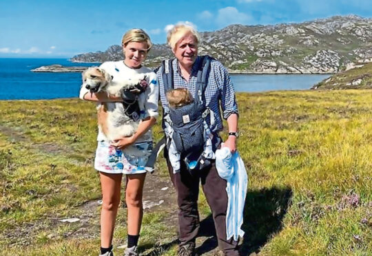 Boris Johnson holding his son with wife Carrie Symonds in Scotland.