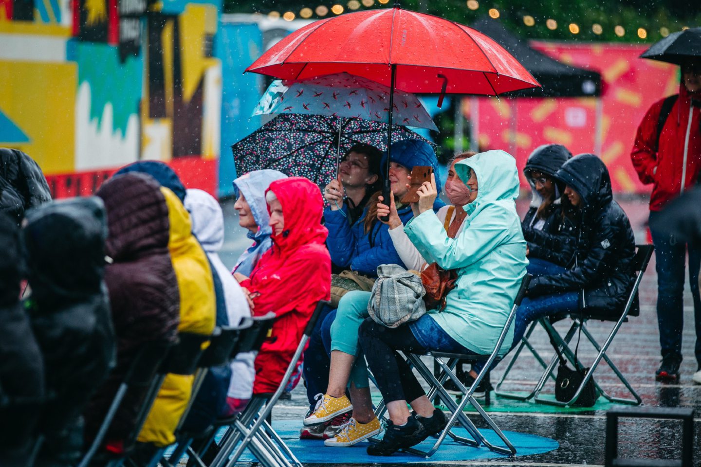 Spectators watching the show in the heavy rain at Multi Story, Castle Terrace