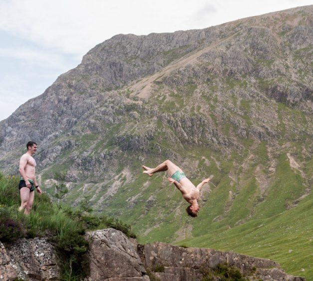 Swimmers do backflips into the River Etive