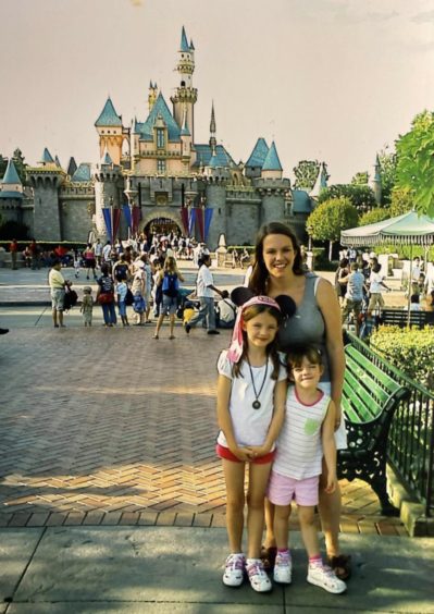 A nine-year-old Iona Jost enjoys park life with mum Hazel and sister Keala at the Disneyland Resort, California in 2007
