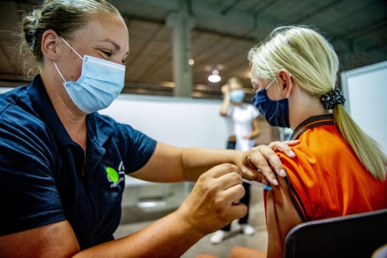 A girl receives the Covid-19 jag at a vaccination centre in Nieuwegein in The Netherlands